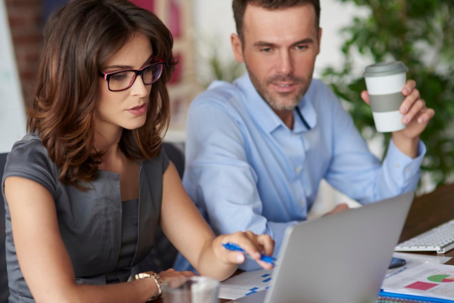Australian family reviewing their monthly budget together at kitchen table